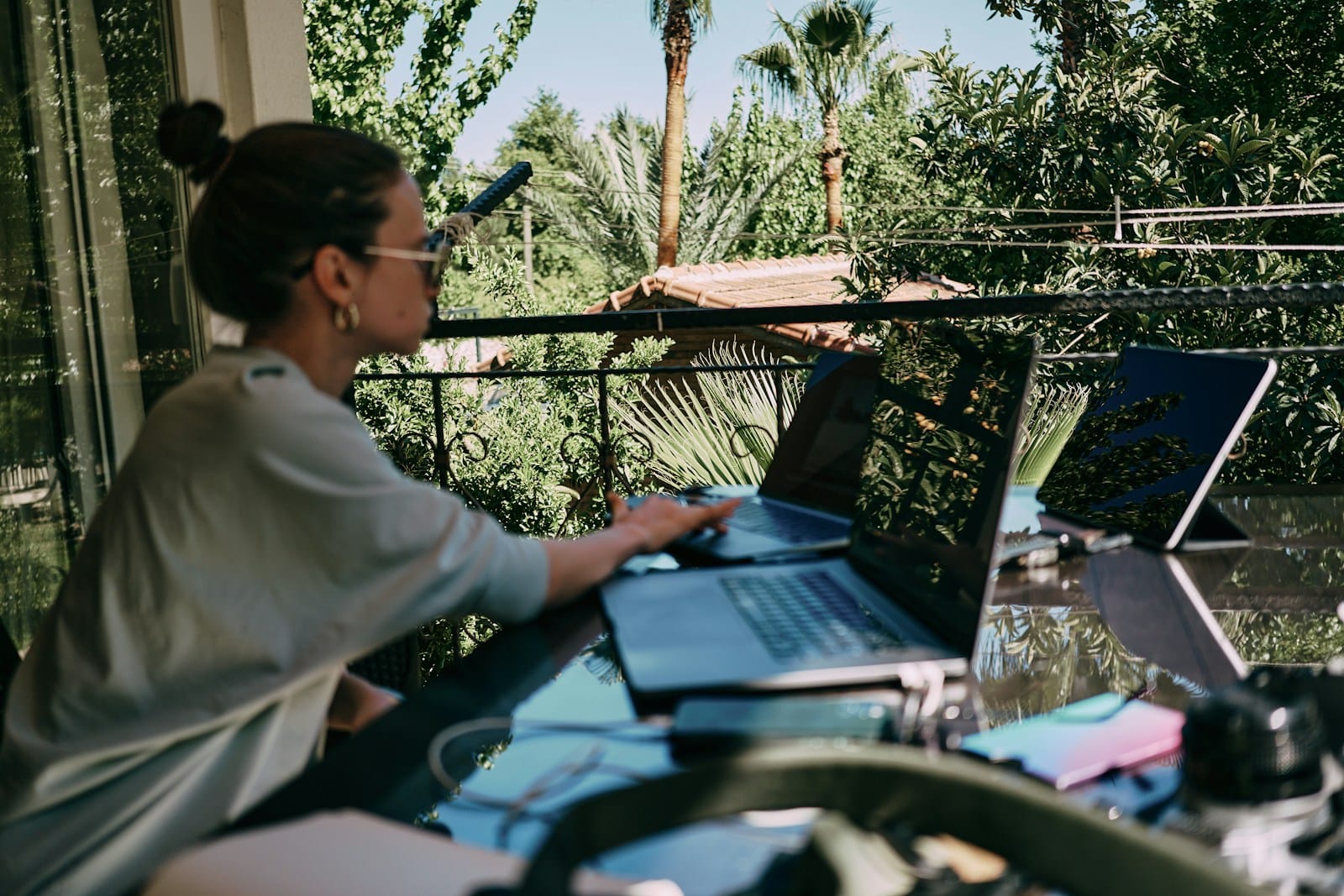 Business che dipende da te: donna che lavora al portatile in terrazza durante le vacanze